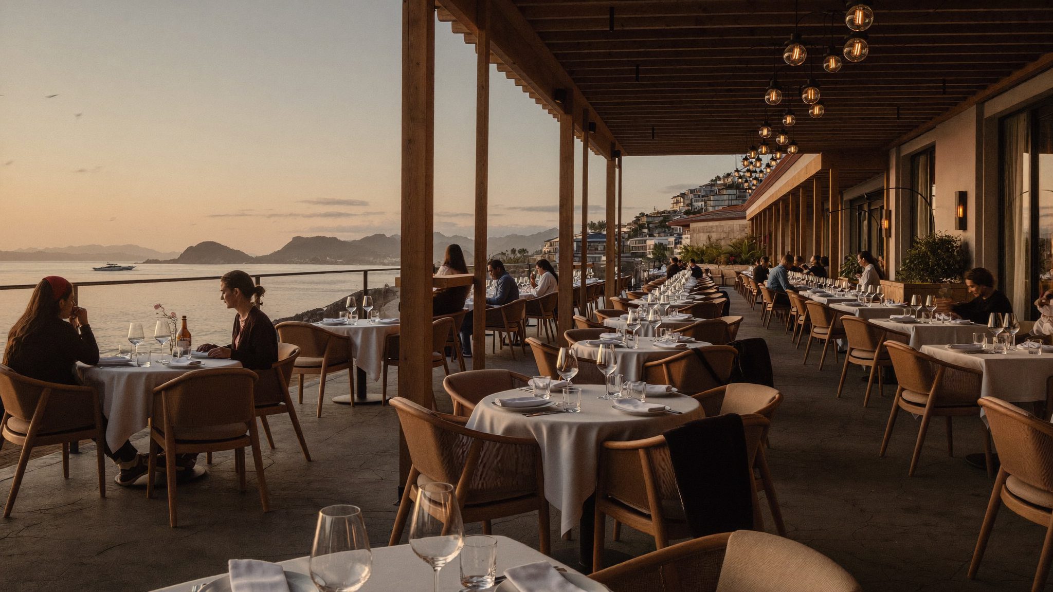Coastal dining at sunset near the restaurant